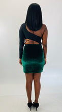 Load image into Gallery viewer, Full-body back view of a size 1X Fashion Nova black one-shoulder long sleeve crop top styled with a green velvet bodycon mini skirt and black pumps on a size 12 model.
